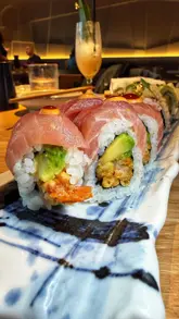 A couple visits Sticks'n'Sushi in Glasgow, showcasing a variety of sushi rolls and a creme brulee dessert.