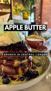 A review-style video of Apple Butter Cafe in Covent Garden, London. The creator showcases the interior, menu, and specific dishes like pancakes and truffle scrambled eggs, while providing a brief critique of the experience and price point.