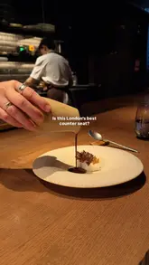 A high-quality, cinematic montage showcasing the live-fire kitchen and intricate plating at Igni in London. The video focuses on the counter seating experience, highlighting the chefs' precision and the quality of the seasonal ingredients.