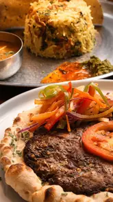 A promotional video for Masala Zone showcasing their family-friendly dining experience, featuring a kids' activity passport, interior shots of the restaurant, and a variety of Indian dishes including samosas, thalis, and biryani.