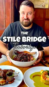 A review of The Stile Bridge, a Michelin-guide gastropub in Kent, showcasing their high-end, fire-cooked dishes like lobster tortellini, bluefin tuna, and a sharing tomahawk steak.