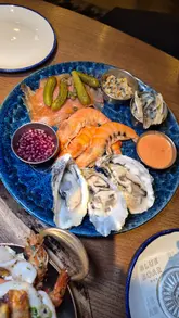 A promotional video for Blue Boar Pub featuring a variety of seafood dishes, fried appetizers, desserts, and a selection of summer-themed spritz cocktails. The video uses quick, rhythmic cuts to showcase the menu items and the pub's interior.