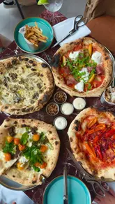 A food review video featuring a visit to No. 32 in Sunderland, highlighting their pizza menu, sides, desserts, and cocktails. The creator provides commentary on the food quality and value, while showing the venue's interior and open kitchen.