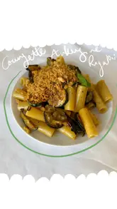 A recipe tutorial video demonstrating how to make creamy fried courgette and aubergine rigatoni with crispy scamorza breadcrumbs. The video follows the cooking process from ingredient preparation to the final plated dish.