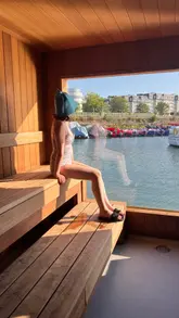A creator visits Ireland's first floating sauna in Dún Laoghaire, providing a tour of the facility, explaining the experience of the wood-fired sauna and the sea plunge, and highlighting the scenic views.