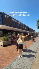 A group of three creators visits Hatters Food & Drinks Hall in Denton, showcasing a variety of dishes from four different independent kitchens located within the venue. The video uses a fast-paced, vlog-style format to highlight specific menu items from each vendor, including waffles, pizza, burgers, and paella.