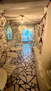 A slow, atmospheric pan of a uniquely decorated cafe interior, highlighting its distinctive white sculptural walls and quiet ambiance.