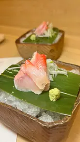 A high-quality, visually focused montage showcasing a seasonal tasting menu at a Japanese Kappo restaurant in London, featuring close-ups of various courses including sashimi, tempura, wagyu, and dessert.