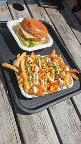 A short, casual video documenting a visit to Rivington Brewing Tap Room, featuring shots of the walk to the venue, the outdoor seating area, and a meal consisting of a vegetarian burger and loaded fries.