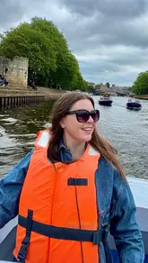 A short, montage-style video showcasing a boat cruise experience in York. The footage includes shots of the boat, the river views, and a relaxing moment with drinks and dessert on board.