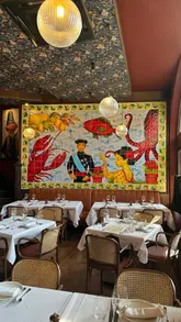 A high-quality, polished showcase of a Basque restaurant located within a pub, featuring close-ups of various dishes including oysters, pintxos, lobster rice, and desserts, alongside shots of the elegant dining room.