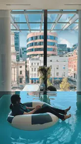 A high-quality promotional video showcasing a luxury daycation experience at the Pan Pacific London. The video features shots of an infinity pool with city views, cocktails, and a brunch spread including waffles, pastries, and buffet items.