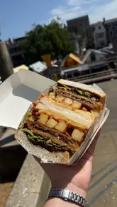 A fast-paced vlog showcasing a visit to the Norwich Lane Summer Fayre, highlighting various street food vendors, coffee shops, and artisan stalls.