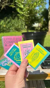 The video demonstrates the process of planting seeds using a Pot Gang subscription box, showing the soil, pots, and seed packets provided in the kit.