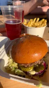 A short montage showcasing a visit to a farm venue featuring a food truck serving burgers and fries, alongside a playground area.