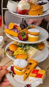 A showcase of an afternoon tea service at Cuthbert's Bakehouse, featuring shots of the exterior, interior, and various sweet and savoury treats.