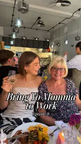 A vlog-style video featuring a creator and her mother visiting 'The Gourmet Spoon' by The Jolly Hog in Peckham. The video documents their experience, including tasting a bacon-focused fry-up, drinking sparkling wine, and enjoying live harp music, all framed within a 'Bring Yo Momma to Work' series.