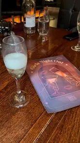 A promotional video for the Heliot Steakhouse at the Hippodrome Casino, highlighting their 'Girls Night Out' bottomless dining package. The video features shots of the casino interior, the table setting, various courses including meatballs, ceviche, steak, salmon, and desserts, and the overall social atmosphere.