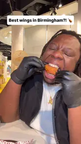 A food review video featuring a creator trying various chicken wing flavours at Wing Fest in Birmingham. The video highlights the different sauces and textures of the wings, including close-up shots of the food and the creator's reactions.