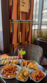A review-style video showcasing the opening of Yibu by Janet in Dublin. The video features the creator introducing the venue, followed by a montage of the interior, various Asian-inspired dishes like dumplings and a spice bag, and cocktails.