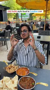 A high-energy vlog-style review of an Indian restaurant in Watford, featuring the creator sampling various vegetarian dishes like paneer tikka, malai kofta, and stuffed kulcha. The video includes shots of the kitchen, the dining area, and the food preparation process.