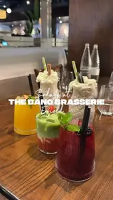 A promotional video for The Banc Brasserie in Enfield, showcasing their Sunday roast menu and signature dishes like mac & cheese and apple crumble French toast. The video features high-quality, slow-motion food shots including gravy and custard pours, set to music with text overlays providing location details.