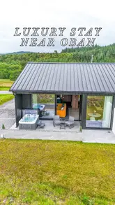 A cinematic tour of a luxury accommodation near Oban, Scotland, showcasing the interior living space, bedroom, kitchen, private hot tub, and scenic sea views, along with access to a nearby spa.