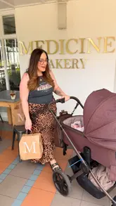 A couple enjoys a 'date day' at Medicine Bakery, starting with food inside and moving to a picnic in the Birmingham Botanical Gardens. The video highlights the pastries, sandwiches, coffee, and the relaxing atmosphere.