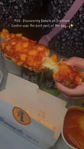 A fast-paced, handheld montage showcasing a variety of Korean street food dishes from Bunsik at the Trafford Centre, including cheese-filled corn dogs, tteokbokki, and bibimbap.