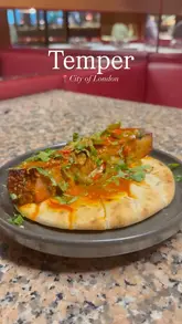 A montage of various dishes and the open-fire cooking style at Temper, City of London, showcasing the restaurant's menu and interior.