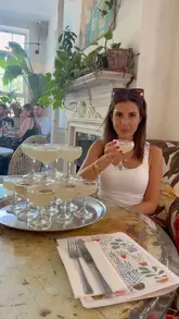 A vibrant, fast-paced reel showcasing a brunch experience at a London venue, highlighting their bottomless margarita tower, various brunch dishes like avocado toast and burgers, and the cozy interior atmosphere.