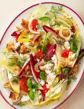 A high-quality, overhead food photography shot of a vibrant, fresh salad featuring shaved fennel, chicory, grapefruit segments, croutons, and fresh dill. The lighting is bright and even, highlighting the textures and colors of the ingredients, making for a highly appealing promotional image for a supper club event.