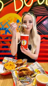 A creator visits the newly opened Dave's Hot Chicken in Liverpool, reviewing the chicken burgers, sides like mac and cheese and fries, and their signature milkshakes. The video features quick cuts, close-ups of the food, and the creator's reaction to the spice levels and flavours.