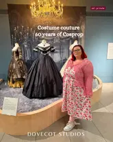 A photo of a visitor standing in front of a costume display at the 'Costume Couture' exhibition at Dovecot Studios.
