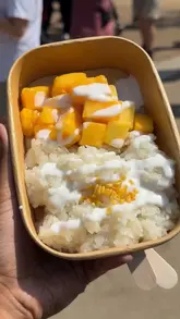 A short, energetic vlog showcasing a Thai festival held at Potter's Field Park near Tower Bridge. The creator highlights various street food options, including mango sticky rice, Thai milk tea, and satay skewers, while capturing the lively festival atmosphere and scenic location.