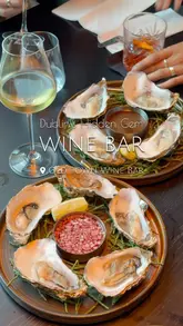 A short, polished montage showcasing the interior, food, and drink offerings of Old Town Wine Bar in Dublin. The video features close-ups of various dishes like oysters, lamb, and shrimp, alongside shots of cocktails and wine, set to music with text overlays identifying the venue.