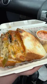 A creator visits Toasted in Bruntsfield, Edinburgh, providing a tour of the interior, showing the menu, and reviewing their toastie order with a close-up cheese pull.