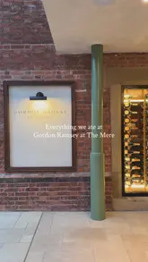 A montage-style video showcasing the interior and various dishes at Gordon Ramsay at The Mere, including cocktails, starters, mains like Beef Wellington, and desserts.