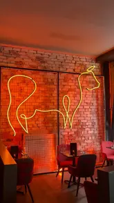 The video provides a tour of 'The Ageing Room' at The Merchant Steakhouse in Glasgow, highlighting its suitability for private dining and events. It features shots of the venue's interior, a selection of canapés including cheeseburger spring rolls, and various drinks like margaritas and wine.