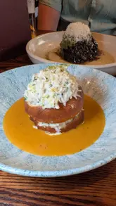 A showcase of new menu items at The Loveable Rogue, featuring close-ups of dishes like ox cheek, crab doughnuts, and savoury churros, along with a shot of the menu and the restaurant exterior.