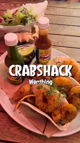 A montage video showcasing various seafood dishes at CrabShack in Worthing, including squid, tacos, a hake burger, and skatewing, set to music with text overlays.