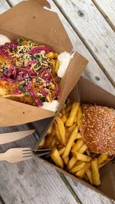 A short vlog-style video visiting Daisy's Milk Shed in Attleborough, Norfolk, showcasing the outdoor venue, the Dirty Fryer Boys food truck, and Heavenly Crumbles dessert truck. The video features shots of the food, the setting, and the creators enjoying their meal.