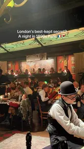 The video provides a montage of an immersive cabaret dining experience in London, themed around 1890s Paris. It features clips of live musicians, performers, and the venue's interior, interspersed with shots of the food served.