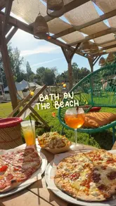 A promotional reel for 'Bath on the Beach,' a temporary pop-up venue in Bath featuring a sandy beach setting, cocktails, pizza, and lawn games.