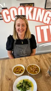 A couple attends an Indian cookery class at a cookery school, showing the process of preparing ingredients, cooking, and eating the final dishes.