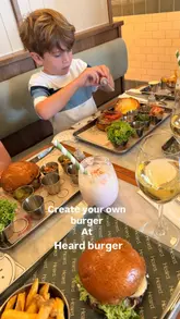 A family-oriented video showcasing a burger restaurant where children can customize their own burgers using a 'mini maker' menu. The video features the kids assembling their meals, parents enjoying drinks, and the final burger product, emphasizing the venue's family-friendly atmosphere.