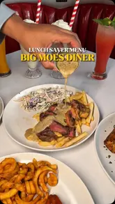 A montage-style video showcasing the Lunch Saver Menu at Big Moe's Diner, featuring close-up shots of various dishes including a double stacker burger, steak, buffalo wings, half chicken, and dessert. The video uses rhythmic cuts and text overlays to highlight the pricing and menu items.