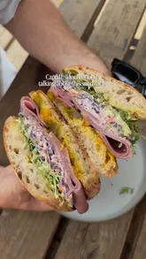 A short, engaging video showcasing a large, stacked pastrami sandwich at Canna Deli in Cardiff. The creator highlights the generous portion size and the hidden nature of the venue, effectively using close-up shots to make the food look highly appealing.