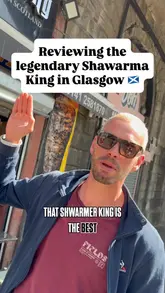 Two creators visit Shawarma King in Glasgow to review their mixed shawarma wrap. The video features the exterior of the shop, the cooking process on the spit, and the creators' honest reactions to the food, highlighting the flavour profile and value.