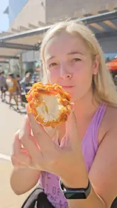 A couple goes for a run to Kargo MKT, where they enjoy a variety of street food including Korean corn dogs, garlic parmesan fries, and tacos, while watching F1.